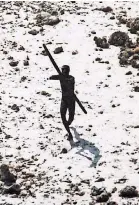  ??  ?? John Chau, an American, wanted to bring Christiani­ty to the isolated people of North Sentinel Island. A tribesman aimed an arrow at an Indian Coast Guard helicopter flying over the island after a tsunami in 2004.