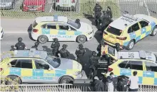  ??  ?? Armed police in College Road, Crawley, on Monday afternoon. Pictures by Eddie Mitchell.