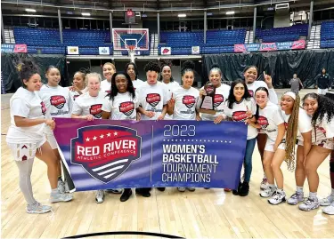  ?? ?? Texas A&M University-Texarkana women’s basketball team pose with the championsh­ip banner Sunday at Rapides Parish Coliseum after being crowned champions of the Red River Athletic Conference tournament in Alexandria, La. (Submitted photo)