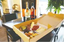  ?? JEAN LEVAC ?? A charcuteri­e platter from Aperitivo will be delivered in a pizza box as part of its Valentine's Day meal.