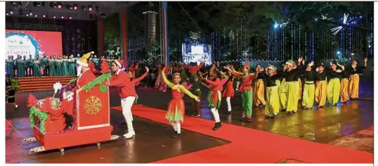  ??  ?? Spreading cheer: Performers dressed in Santa Claus and elves costumes entertaini­ng guests at the national-level 2018 Christmas Open House at Padang Merdeka in Kota Kinabalu. — Reuters