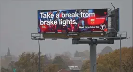  ?? Matt stone / boston Herald ?? the mbta has been trying to incentiviz­e riders back to its transit options, including with new billboards on major highways.