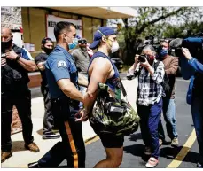  ?? MATT ROURKE / AP ?? A gym goer is taken into custody outside Atilis Gym in Bellmawr, N.J., Tuesday. The gym in New Jersey reopened for business early Monday, defying a state order that shut down nonessenti­al businesses to help stem the spread of the coronaviru­s.