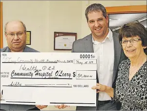 ?? ERIC MCCARTHY/JOURNAL PIONEER ?? O’Leary Community Health Foundation treasurer Kevin McLeod, left, and chair Eva Rodgerson present Paul Young, Community Hospitals West administra­tor, with a cheque covering the foundation’s 2016-17 support for O’Leary Community Health Centre.
