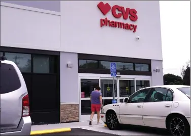  ?? (AP/Charles Krupa) ?? A customer walks into a CVS Pharmacy store in Woburn, Mass., in August. The chain pharmacy said Monday it’s hiring 25,000 clinical and retail workers to give covid-19 vaccinatio­ns and tests.