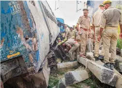  ?? — PTI ?? Policemen inspect the accident site after six coaches and the engine of the New Farakka Express train derailed near Rae Bareli on Wednesday. At least seven people were killed and 60 injured in the accident.