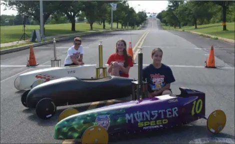  ?? MARIAN DENNIS — MEDIANEWS GROUP ?? Jada Soley, Hanna Harmanos and Tito Vidal pose with their trophies and cars after coming in first in their divisions Saturday at the Pottstown Soap Box Derby.