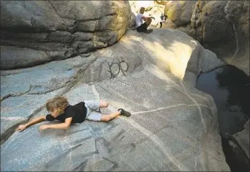  ?? Wally Skalij Los Angeles Times ?? A BOY struggles to hang on to a slippery rock at Hermit Falls in Angeles National Forest. The L.A. County Sheriff’s Department’s Search and Rescue teams are seeing more missions, and officials blame social media.