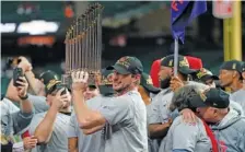  ?? AP PHOTO/DAVID J. PHILLIP ?? Washington Nationals starting pitcher Max Scherzer celebrates with the championsh­ip trophy after Game 7 of the 2019 World Series against the host Houston Astros this past Oct. 30.