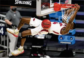  ?? MICHAEL CONROY / AP ?? Arkansas guard Davonte Davis gets a dunk against Texas Tech during their 68-66 win Sunday to earn a spot in the Sweet 16. The Razorbacks will play another surprising upstart — and familiar opponent — Oral Roberts on Saturday. They beat the Golden Eagles 87-76 on Dec. 20.