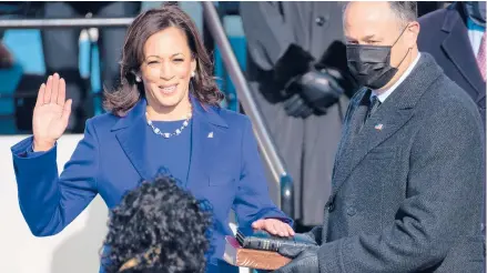  ?? SAULLOEB/GETTY ?? Kamala Harris is sworn in as vice president by Supreme Court Justice Sonia Sotomayor as Harris’ husband, Doug Emhoff, holds a Bible during Wednesday’s inaugurati­on at the U.S. Capitol in Washington.