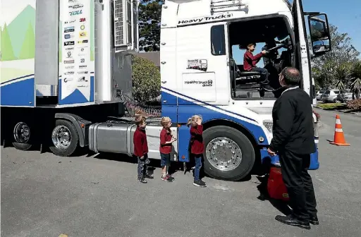  ?? MARTIN DE RUYTER/ THE LEADER ?? Stoke school children climb into the cab of the Safety MAN truck, during the visit to promote truck safety.