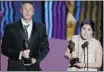  ?? Gary Hershorn, Reuters ?? Daniel Junge and Sharmeen Obaid-chinoy accept their Oscars Feb. 26 for Saving Face.