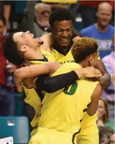  ?? ETHAN MILLER/GETTY IMAGES ?? Dillon Brooks, left, and Oregon earned a No. 1 seed in the NCAA Tournament after routing Utah 88-57 to win the Pac-12 championsh­ip.