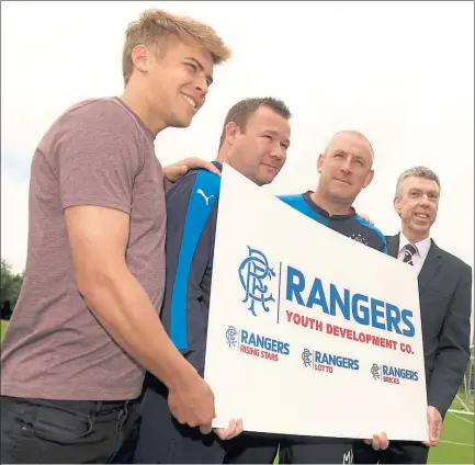  ??  ?? REBUILDING FOR THE FUTURE: Mark Warburton, second-right, promotes the Rangers Youth Developmen­t Company