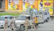  ?? AP ?? Cops coming out of a store belonging to Dera Sacha Sauda after sealing it near Sonepat on Saturday.