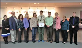  ?? Courtesy photo ?? (Top) Girl Scout Alex Karpp of Troop 8722, center, stands with her family and Saugus Union School District Governing Board members at a board meeting honoring her for her Silver Award Project on Tuesday. (Below) Boy Scout Gage Smith, center, stands...