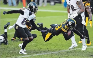  ?? JOE SARGENT GETTY IMAGES ?? Steelers’ Joe Haden carries for a TD after intercepti­ng a pass in the first quarter against Baltimore in Pittsburgh on Wednesday. The Steelers won to remain the only unbeaten team this season.