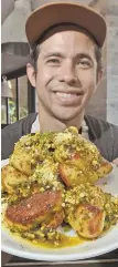  ?? STAFF PHOTO BY PATRICK WHITTEMORE ?? TRY A BITE: Pastry chef Kenny Hoshino of Waypoint shows off his Pistachio Garlic Knots at the Seaport eatery yesterday.