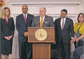  ?? PHOTOS COURTESY OF CAPITAL NEWS SERVICE/HANNAH KLARNER ?? Gov. Larry Hogan, center, speaks at a press conference to announce MD Think in Annapolis on March 9. The new program is designed to allow state agencies to share informatio­n about their clients more easily to provide better service.