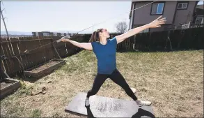  ?? David Zalubowski / Associated Press ?? Olympic javelin thrower Kara Winger uses a cable system to simulate throwing a javelin as she trains outside her home in Colorado Springs, Colo. The coronaviru­s crisis has forced many athletes to be creative as they try to continue their training.