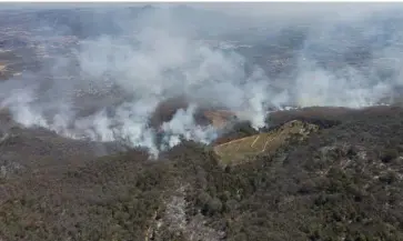  ?? ENRIQUE CASTRO/AGENCE FRANCE-PRESSE ?? AERIAL view of a forest fire that affects an avocado plantation in Cerro del Aguila, recognized as a Protected Natural Area and Forest Restoratio­n site, in Morelia, state of Michoacan, Mexico. Forest fires affecting 18 of Mexico’s 32 states have devastated 3,049 hectares of forested areas as of Tuesday, according to a report by authoritie­s.