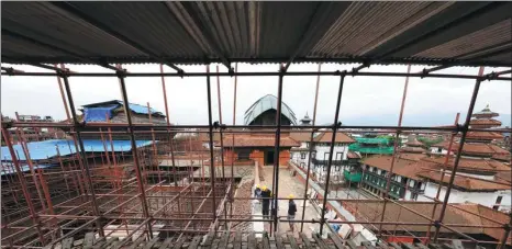  ?? PHOTOS BY YUAN MENGXI /FOR CHINA DAILY ?? Top: The Ta Keo Temple at the Angkor complex is being renovated by Chinese workers. Above: Restoratio­n work on the nine-story Basantapur Tower in Kathmandu, the capital of Nepal, began last year and is scheduled to last for five years.
