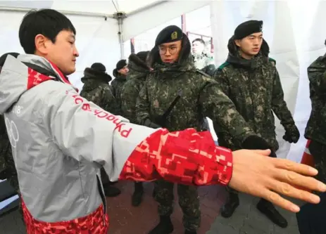  ?? JUNG YEON-JE/AFP/GETTY IMAGES ?? South Korean soldiers were called in to work at Olympic venues while security guards are under quarantine while waiting to be tested for the norovirus.