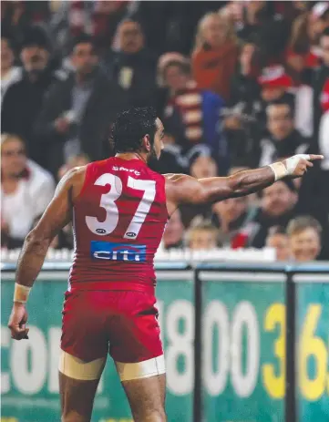  ??  ?? Adam Goodes points into the crowd alerting security to an individual, who turned out to be a 13-year-old girl, who was calling racist slurs which cut the Sydney star deeply.