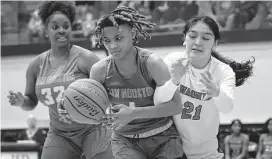  ?? ?? Wagner’s Alina Garza (21) gets her arm intertwine­d against Sam Houston’s Cheyenne Mitchell.