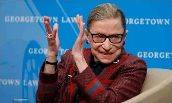  ?? AP Photo/Alex Brandon ?? In this 2018 file photo, Supreme Court Justice Ruth Bader Ginsburg applauds after a performanc­e in her honor after she spoke about her life and work during a discussion at Georgetown Law School in Washington.