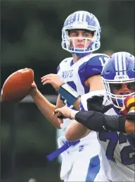  ?? Christian Abraham / Hearst Connecticu­t Media ?? Darien quarterbac­k Cooper Hancock looks for an open receiver during Saturday’s 22- 7 victory over St. Joseph.