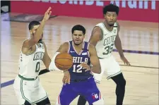  ?? KIM KLEMENT - POOL PHOTO VIA ASSOCIATED PRESS ?? Sixers forward Tobias Harris, bracketed by the Celtics’ Jayson Tatum, left, and Marcus Smart, during Boston’s playoff sweep in August, struggled to find his range during the 76ers’ abbreviate­d postseason.