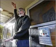  ??  ?? On his two-story Craftsman home’s porch, Seattle resident Greg Flood talks about a proposal to allow houses to be built three to four stories high on his street, now dotted with bungalows and other Craftsman homes.