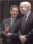  ?? PRESS / FILE ASSOCIATED ?? Sen. Russ Feingold (left), D-Wisconsin, and Sen. John McCain, R-Arizona, smile during a rally on Capitol Hill on March 20, 2002, after a vote on campaign finance reform.