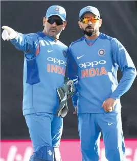  ?? Picture: AFP ?? NOT FINISHED YET. MS Dhoni (left) still has a vital role to play, according to captain Virat Kohli.