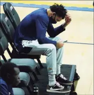  ?? David Butler II / USA TODAY ?? UConn guard James Bouknight sits on the sideline as his teammates warm up before a game against Butler in Storrs on Jan. 26.