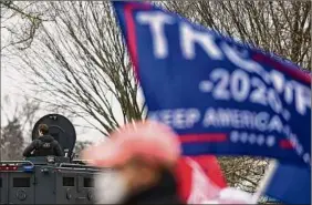  ?? Astrid Riecken / For The Washington Post ?? Secret Service protect the area around the White House where thousands of supporters of former President Donald Trump gather in Washington on Jan. 6, 2021.