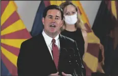  ?? ASSOCIATED PRESS ?? ARIZONA GOV. DOUG DUCEY SPEAKS during a news conference Aug. 31 regarding the latest informatio­n on the coronaviru­s and the upcoming flu season as Arizona Department of Health Services Director Dr. Cara Christ, right, listens.