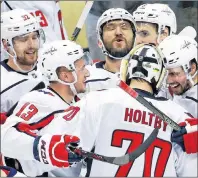  ?? AP PHOTO ?? Washington Capitals’ Alex Ovechkin, top centre, celebrates with teammates after beating the Pittsburgh Penguins Monday in Pittsburgh.