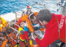  ?? Olmo Calvo The Associated Press file ?? A baby is loaded into the rescue vessel of the Spanish NGO Proactiva Open Arms on Dec. 21 after being rescued in the Central Mediterran­ean Sea.