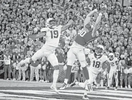  ?? Brett Deering / Getty Images ?? OU tight end Grant Calcaterra pulls in a touchdown catch against linebacker Montrel Wilson, left, and the TCU defense Saturday. The Sooners won to take command of the Big 12 race, but they might face the Horned Frogs in the conference title game Dec. 2.