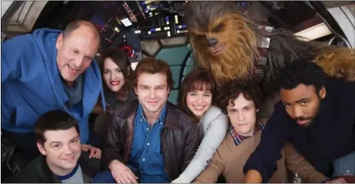  ?? JONATHAN OLLEY — COURTESY OF LUCASFILM LTD. ?? Shown in a photo related to the Harrelson, Phoebe Waller-Bridge, Alden Glover. Ehrenreich, are, clockwise from bottom left: co-director Christophe­r Miller, Woody Emilia Clarke, Joonas Suotamo as Chewbacca, co-director Phil Lord and Donald