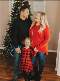  ?? (AP/Jade Ware) ?? Nick Jones poses with wife Mindy and their daughter, Gracelyn, in front of one of their decorated Christmas trees at their home in Louisville, Ky.