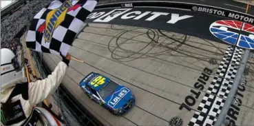  ?? SEAN GARDNER, GETTY IMAGES ?? Jimmie Johnson crosses the finish line to win the weather-delayed Food City 500 at Bristol Motor Speedway on Monday.