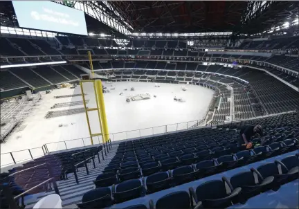  ?? TONY GUTIERREZ — THE ASSOCIATED PRESS ?? Worker Raul Camacho clean seats inside the newly constructe­d Globe Life Field in Arlington, Texas, on Wednesday, March 11, 2020.