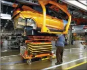  ?? THE ASSOCIATED PRESS ?? A battery is lifted into place for installati­on in the Chevrolet Bolt EV at the General Motors Orion Assembly plant Friday in Orion Township, Mich.