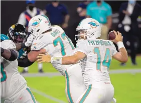  ?? PHELAN M. EBENHACK/ASSOCIATED PRESS ?? Miami quarterbac­k Ryan Fitzpatric­k threw for two scores and ran for another in the Dolphins’ victory against Jacksonvil­le on Thursday night.