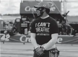  ??  ?? Bubba Wallace wears a shirt in support of George Floyd and Black Lives Matter at Atlanta Motor Speedway.