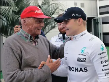  ?? Picture: AP Photo/Sergei Grits ?? MEETING A LEGEND: Mercedes driver Valtteri Bottas of Finland, right, shakes hands with three-time world champion Niki Lauda after winning the Russian Grand Prix.